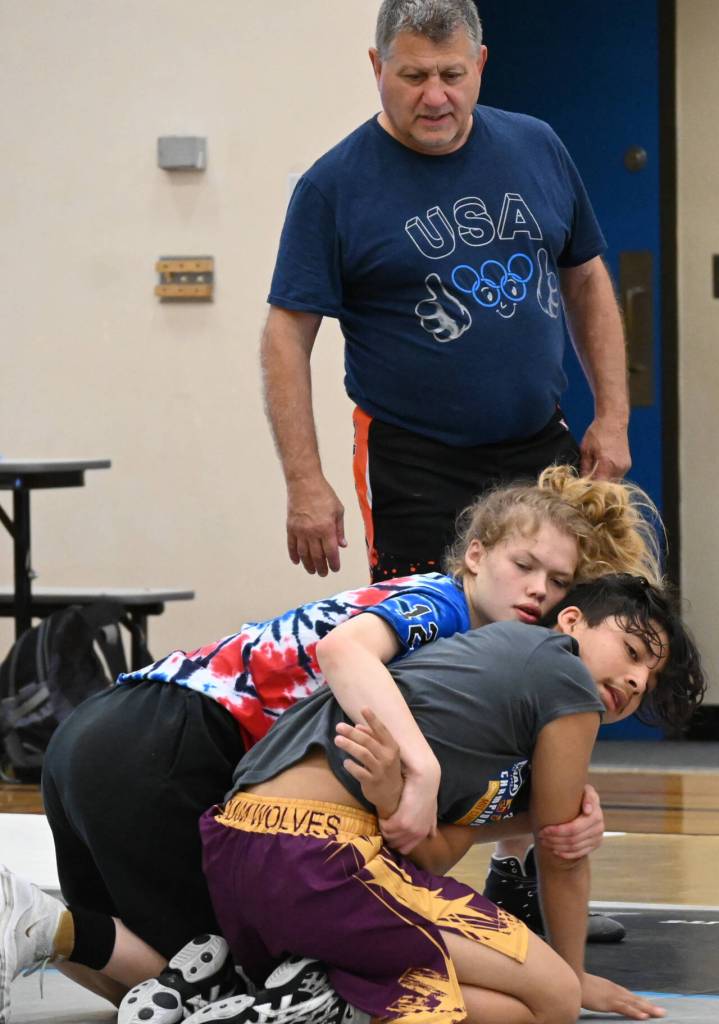 Sequim Gazette photo by Michael Dashiell / Former collegiate, national and world wrestling champion Gene Mills, left, works with campers at a summer camp in Sequim last week.