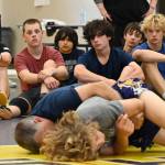 Sequim Gazette photo by Michael Dashiell / Campers look on as Gene Mills demonstrates a move with Sumners Cody Miller at a summer camp in Sequim last week.
