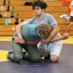 Sequim Gazette photoS by Michael Dashiell
Aaron Tolberd, top, and Ari Skov of Sequim work on a move at a wrestling camp last week.