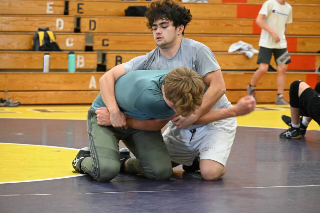 Sequim Gazette photoS by Michael Dashiell
Aaron Tolberd, top, and Ari Skov of Sequim work on a move at a wrestling camp last week.
