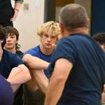 Sequim Gazette photo by Michael Dashiell / Campers listen in as Gene Mills details a move at a wrestling camp in Sequim last week.