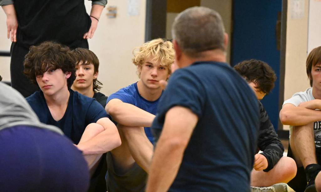 Sequim Gazette photo by Michael Dashiell / Campers listen in as Gene Mills details a move at a wrestling camp in Sequim last week.