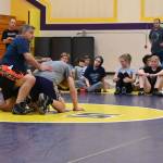 Sequim Gazette photo by Michael Dashiell / Campers listen in as Gene Mills demonstrates a move with Sumners Cody Miller at a summer camp in Sequim last week.