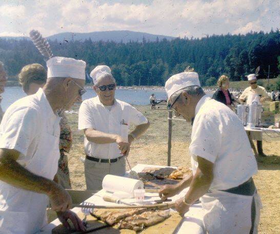 Submitted photo / Bob Thompson two others serve at Sequims first Salmon Bake, held 53 years ago (1969) at Pit Ship Point, now home to John Wayne Marina.