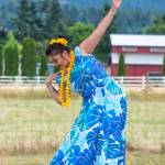 Sequim Gazette photo by Emily Matthiessen
Alakai in training, Casara Desiree Hemakanamaikapu`uwai Caro demonstrates a hula for an audience in the field behind the Sequim Library on July 16. Her mother, Candace Marie Kananiokamokihana Melendez of Halau Hula Ka Lei Mokihana I Ka Ua Noe, said that her daughter began learning the hula in the womb. North Olympic Library System hosted the dance, history and language workshop as part of their summer reading program.