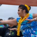 Sequim Gazette photo by Emily Matthiessen / Alakaʻi in training, Casara Desiree Hemakanamaikapu`uwai Caro leads members of a Sequim audience in a Hawaiian dance in the field behind the Sequim Library on July 16. Her mother, Candace Marie Kananiokamokihana Melendez of Hālau Hula Ka Lei Mokihana I Ka Ua Noe, plays the ukulele on the stage. North Olympic Library System hosted the dance, history and language workshop as part of their summer reading program.