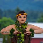 Sequim Gazette photo by Emily Matthiessen / Alakaʻi in training, Casara Desiree Hemakanamaikapu`uwai Caro demonstrates a hula for a Sequim audience on Saturday in the field behind the Sequim Library on july 16. Her mother, Candace Marie Kananiokamokihana Melendez of Hālau Hula Ka Lei Mokihana I Ka Ua Noe, said that her daughter began learning the hula in the womb. North Olympic Library System hosted the dance, history and language workshop as part of their summer reading program.