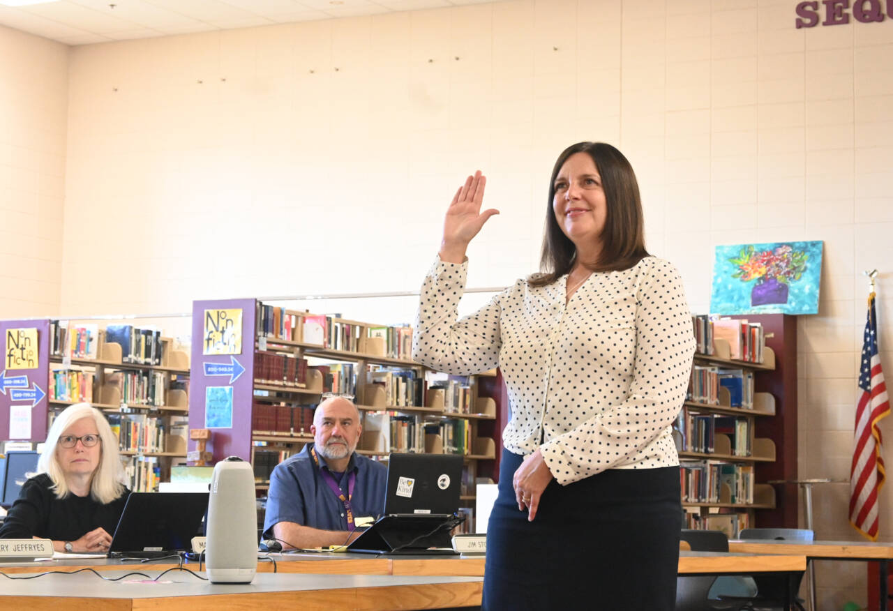 Sequim Gazette photo by Michael Dashiell
New Sequim schools superintendent Regan Nickels takes her oath of office at a Sequim School Board meeting on July 18. Looking on are school board directors Maren Halvorsen and Jim Stoffer.