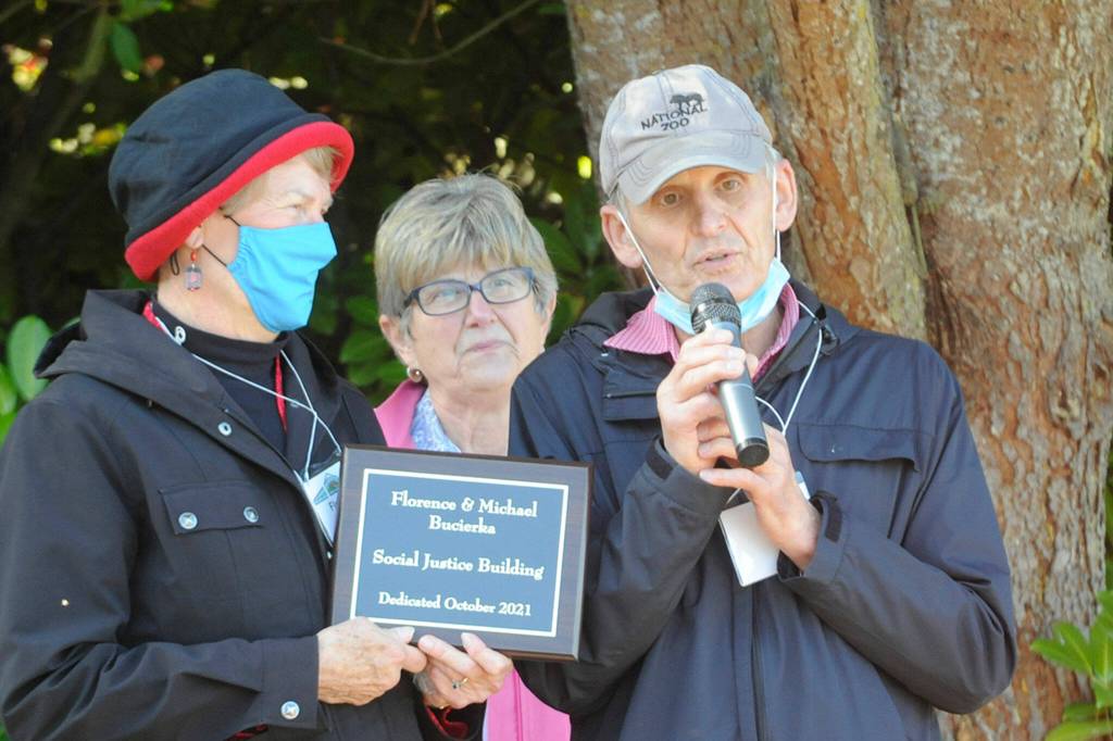Florence and Michael Bucierka, on left and right, accept a plaque from Vicki Sensiba, center, on Oct. 10 that names the Olympic Unitarian Universalist Fellowships Little Free Pantry expansion/Social Justice Building after them for their efforts to help develop it. Sequim Gazette photo by Matthew Nash