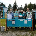Sequim Gazette photo by Matthew Nash
Agnew Little Free Pantry volunteers greet Sara Irish, a Molina Healthcare community engagement specialist, fifth from left, as she donates $2,000 for food from the agency. Some of the volunteers who work daily to restock the pantry, include, from left, Susan Harris, Dave Large, Florence and Michael Bucierka, Irish, Peggy and John Toppenberg, Dave Iezzi, and Ren Garypie.