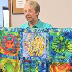 Sequim Gazette photo by Michael Dashiell
Betty Cook, pictured holding Sea Life, celebrates her win in the Sunbonnet Sue Quilt Clubs annual competition (small quilts division) following their annual show, held over one day during Lavender Weekend on July 16.