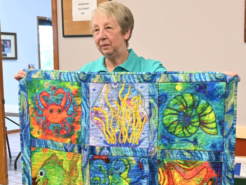 Sequim Gazette photo by Michael Dashiell
Betty Cook, pictured holding Sea Life, celebrates her win in the Sunbonnet Sue Quilt Clubs annual competition (small quilts division) following their annual show, held over one day during Lavender Weekend on July 16.