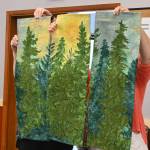 Sequim Gazette photo by Michael Dashiell / Sunbonnet Sue Quilt Club members hold up Anne Davies Summer Sunrise, which tied for first place in the clubs annual show for top art quilt (with Gladis Marrs Fiesta).