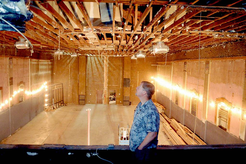 Photo by Keith Thorpe/Olympic Peninsula News Group / Lincoln Theater co-owner Marty Marchant looks at the exposed rafters of the theater on July 30 after they were uncovered by workers who removed the ceiling the previous week.