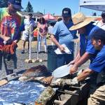 Sequim Gazette photo by Michael Dashiell / Rotary Club of Sequim members help prepare salmon for hungry event attendees at the clubs annual Salmon Bake, held in conjunction with the 2022 Unity of Effort event at Security Services Northwest on Aug. 6. Pictured, from left, are: Hosea Bostic, a visiting Rotarian from Nevada City, Calif.; John Bertholl, friend of a Rotary club member; Rotarian Paul McHugh; and, Jason Bausher, immediate past president of the Sequim Noon Rotary.