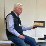 Sequim Gazette photo by Matthew Nash/ Jim Kloetzel of Sequim shares a postage cover thats been passed down through his family featuring his last name from a moving company in Detroit, Mich. Each month, Strait Stamp Society members pick a letter choose a stamp-related item to share with Augusts letter K.