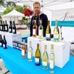 Photo by Emma Jane Garcia/Sequim Farmers & Artisans Market
Scott Rants of Seabeck Cellars greets customers at the companys booth at the Sequim Farmers & Artisans Market.