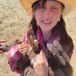 Sequim Gazette photo by Matthew Nash/ McKinley Huntington of Sequim cools off her rabbit Whatchamacallit with some ice on his tummy before she auctioned him off during the Clallam County Junior Livestock Auction.