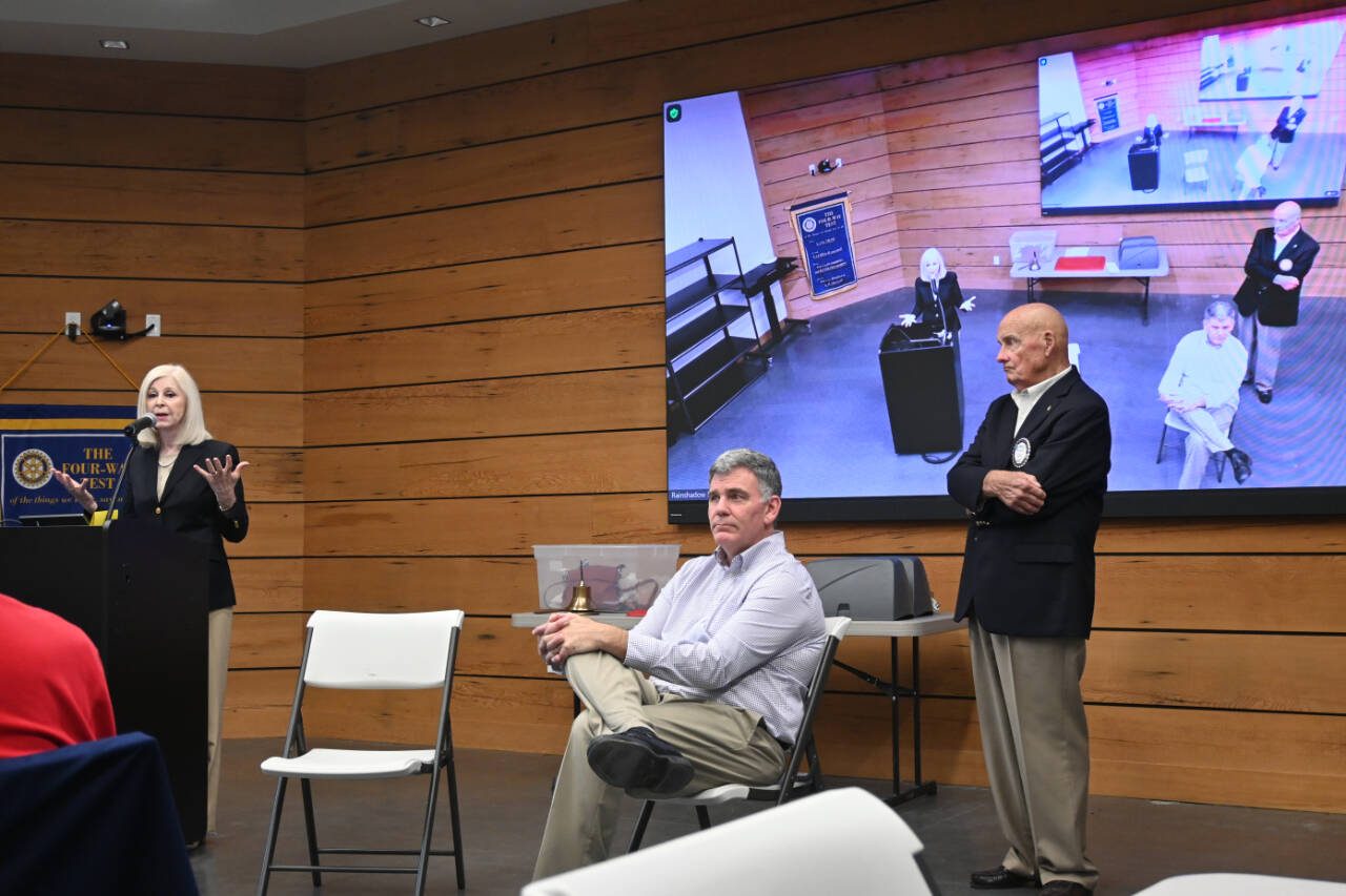 Sequim Gazette photo by Michael Dashiell / Cherie Kidd and Bruce Emery (seated), candidates for Clallam County Director of Community Development, speak at a debate hosted by the Rotary Club of Sequim at the Dungeness River Center on Aug. 5. Looking on is debate moderator Mike McAleer.