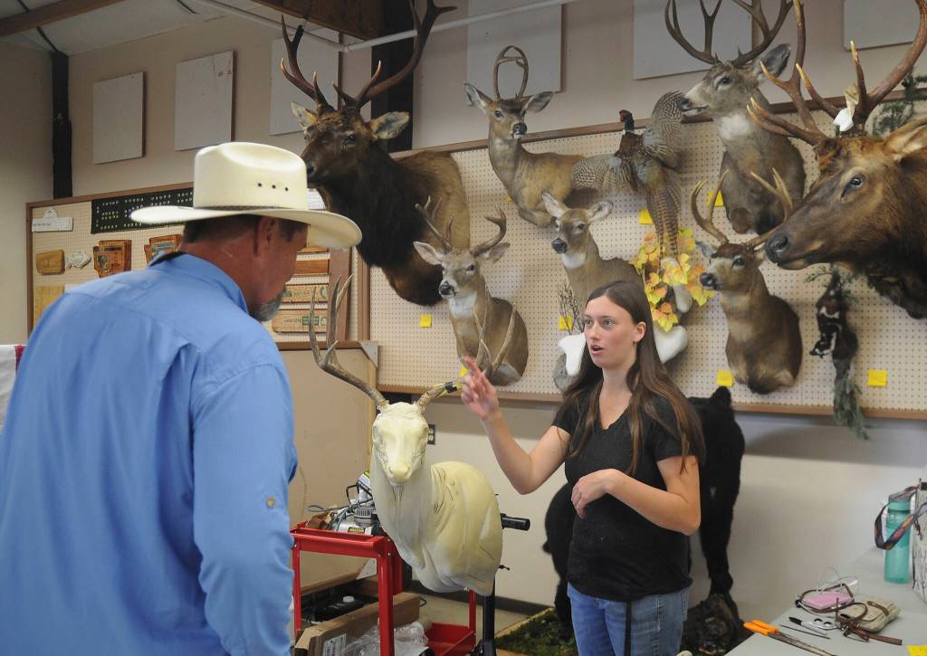 Sequim Gazette file photo by Michael Dashiell / Elizabeth Barrett of West End Taxidermy talks with a fair-goer at the Clallam County Fair in 2019; Davis is part of the Happy Tails 4-H Club.