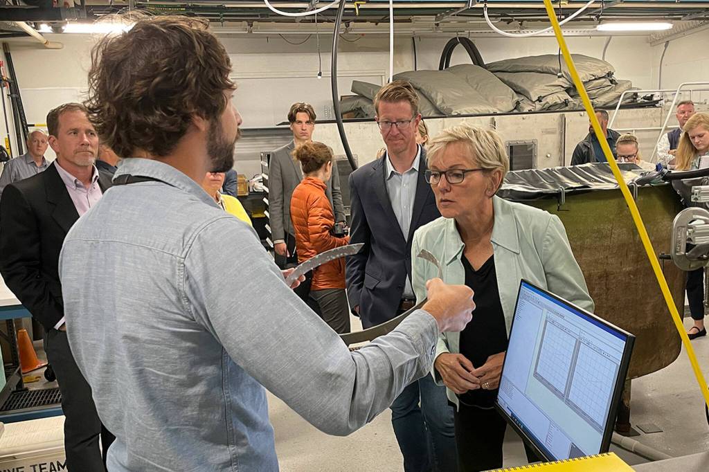 Sequim Gazette photo by Matthew Nash/ Rob Cavagnaro with PNNL-Sequim shows Jennifer Granholm, U.S. Secretary of Energy, U.S. representative Derek Kilmer, and others a wearband sliding bearing thats rusted as part of a prototype wave energy converter biofouling test. Researchers looks to reduce maintenance costs for companies in the ocean by testing how residue accumulates and best methods for keeping it off.
