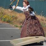 Sequim Gazette photo by Emily Matthiessen / During Olympic Theatre Arts Renaissance Faire on Sunday, Queen Elizabeth I, played by Sarah Tucker, tosses a rat at the same time a hoop sales past her.