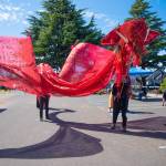 Sequim Gazette photo by Emily Matthiessen / During Olympic Theatre Arts Renaissance Faire last weekend, members of The Hobbit production parade their dragon puppet Smaug through OTAs parking lot.