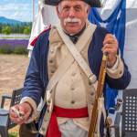 Sequim Gazette photo by Emily Matthiessen / Fred Gilbert of Silverdale, with the John Paul Jones Chapter of the Sons of the Revolution, explains how to load a musket to visitors at the PNW Colonial Festival. He said, I do this to honor my fourth great grandfather, Sergeant John Gilbert of the 8th Connecticut Unit, a survivor of the Revolutionary War, wounded at Yorktown.