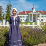 Sequim Gazette photo by Emily Matthiessen / Juliet Griev, standing in front of the George Washington Inn, acquired her white cap at the Northwest Colonial Festival on Friday, completing a beautiful outfit.