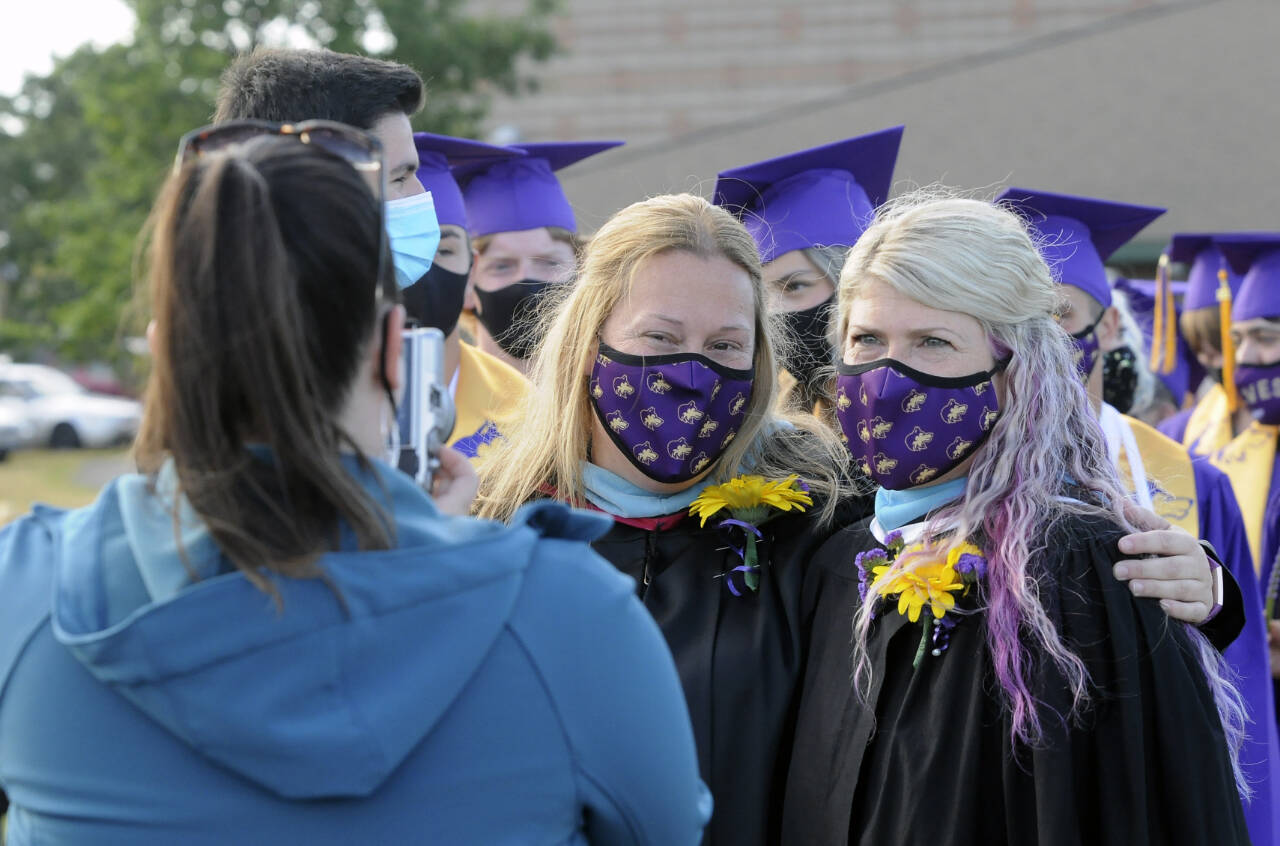 Sequim Gazette file photo by Michael Dashiell / Erin Fox, left, poses for s photo with fellow Sequim High School staffer Melee VenderVelde at the 2021 SHS graduation ceremony. A Sequim High graduate, Fox was named the schools principal on Aug. 15.