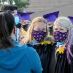 Sequim Gazette file photo by Michael Dashiell / Erin Fox, left, poses for s photo with fellow Sequim High School staffer Melee VenderVelde at the 2021 SHS graduation ceremony. A Sequim High graduate, Fox was named the schools principal on Aug. 15.