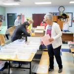Sequim Gazette file photo by Michael Dashiell / Volunteers at Back to School Fair at the Sequim Boys & Girls Club organize school supply kits for local students in 2018. This years event, set for Aug. 27, features a drive-through and on-the-field fair at the Sequim School District stadium on West Fir Street.