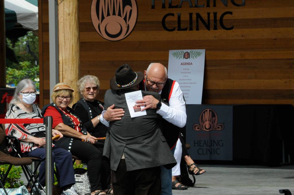 Sequim Gazette photo by Matthew Nash/ W. Ron Allen, tribal chairman of the Jamestown SKlallam Tribe, hugs Tim Wheeler, a Sequim resident, after giving him the first Jamestown Healing Clinic T-shirt. Brent Simcosky, the tribes health services director, said Wheeler was a big supporter of the tribe and the clinic, and the first in line at a forum they held to speak in support.