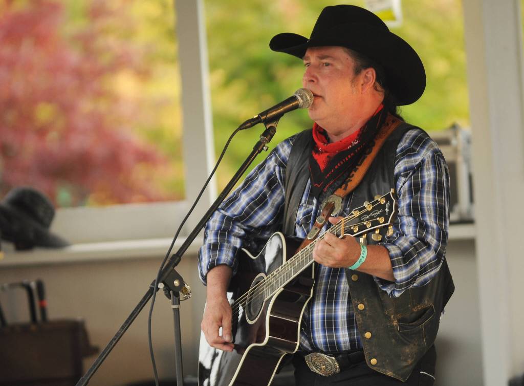 Sequim Gazette photo by Michael Dashiell / Buck Ellard plays for the Clallam County Fair audience at the Sunny Farms Stage on Aug. 18.