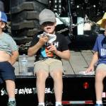 Photo by Keith Thorpe/Olympic Peninsula News Group / Siblings, from left, Charlie Jones, 4, Samuel Jones, 8, and August Jones, 6, all of Port Angeles, eat fresh scones on Aug. 18 at the Clallam County Fair.