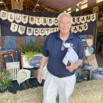 Photo by Paula Hunt/Olympic Peninsula News Group / Ron Crawford, one of seven Washington State Fair commissioners, visited the Clallam County Fair on Aug. 20 to evaluate it in a wide range of categories from the quality of its livestock and agricultural exhibits to cleanliness to the education value of displays.