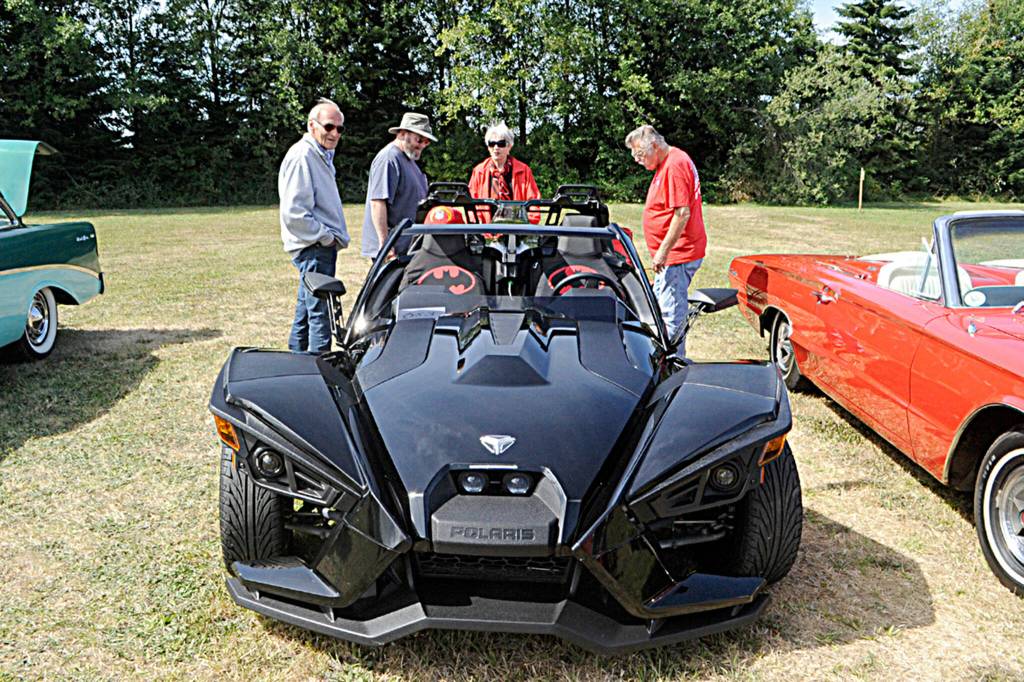 Don and Donna Alexander of Sequim, right, discuss their Polaris Slingshot with Jack McEwan and friend Berk Webster at the Air Affaire on Aug. 27.