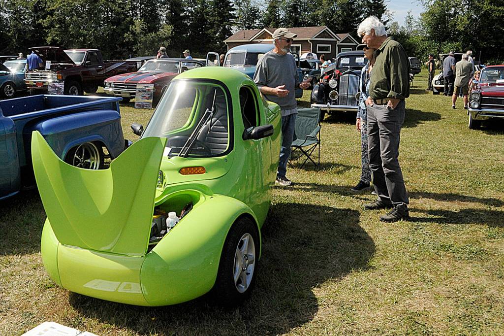 Rob Bryant of Sequim talks about his 2000 Corbin Sparrow electric car with Barry and Sydna Baker also of Sequim. The couple said they come every year to the Air Affaire and say it helps promote community.