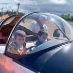 Sequim Gazette photos by Matthew Nash
Kevin Tracy of Sequim helps brothers Silas, 7, and Zeke, 9, Smith sit in his 1946 Ercoupe 415-C airplane at the Air Affaire at the Sequim Valley Airport on Aug. 27.