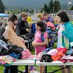 Sequim Gazette photo by Matthew Nash
Jen Williams looks at clothes with Linnea, 8, and Sophia, 11, Mager at the Back to School Fair. The sisters will be going into third and sixth grades, they said. See story and more photos of the event on page A3.