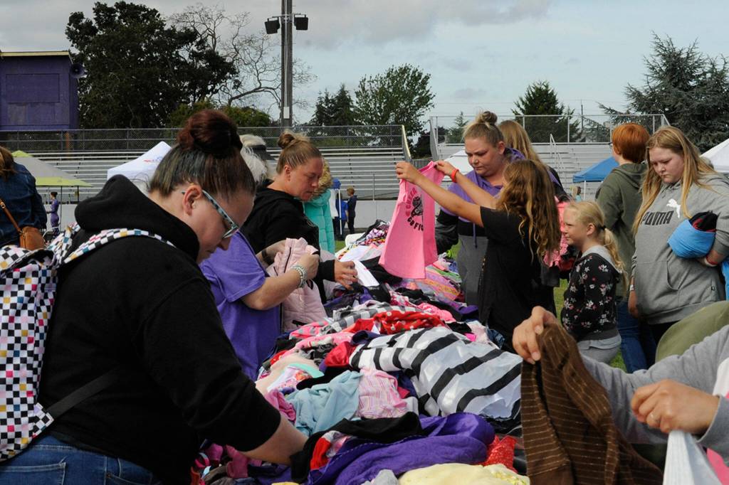 Sequim Gazette photo by Matthew Nash/ Donated childrens clothes were a popular draw at the Back to School Fair. It was one of many attractions, including many community booths and a drive through for school supplies.
