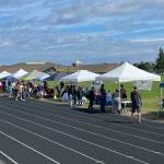 Sequim Gazette photo by Matthew Nash/ About 30 booths lined the Sequim School District Athletic Field for the Back to School Fair offering sign-ups, special activities and more.