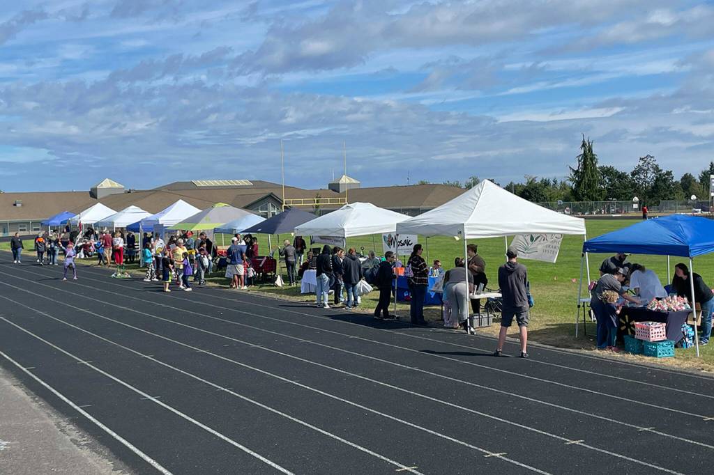 Sequim Gazette photo by Matthew Nash/ About 30 booths lined the Sequim School District Athletic Field for the Back to School Fair offering sign-ups, special activities and more.