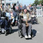 Photo by Keith Thorpe/Olympic Peninsula News Group / Ian Mackay of Agnew, center, prepares to lead a group of wheelchair, bicyclists, runners and others on a portion of Sea-to-Sound, a three-day, 74-mile multi-modal group ride along a section of the Waterfront Trail in Port Angeles on Aug. 27. The excursion, which followed numerous portions of the Olympic Discovery from west of Lake Crescent to the Larry Scott Trail in Jefferson County, ended Aug. 28. It was organized through Ians Ride, a nonprofit organization the advocates outdoor accessibility for all.