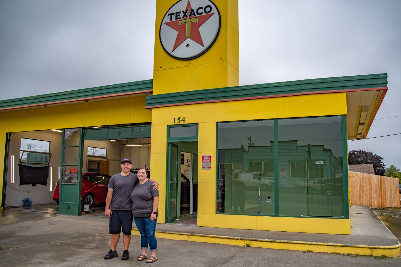 Sequim Gazette photo by Emily Matthiessen / Christopher Burris and his sister Kim Burris stand outside the Texaco their grandfather used to own, which Burris now rents to operate Exquisite Reflection Details, his auto-detailing business, which moved to the 154 E. Washington St. address in early August.