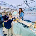 Photo by Emma Jane Garcia/Sequim Farmers & Artisans Market / Sarah Harrington greets customers at the Cookie Daughters booth at the Sequim Farmers & Artisans Market.