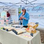 Photo by Emma Jane Garcia/Sequim Farmers & Artisans Market / Sarah Harrington greets customers at the Cookie Daughters booth at the Sequim Farmers & Artisans Market.