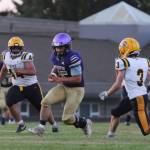 Sequim Gazette photos by Michael Dashiell
Sequims Thomas Reandeau looks for running room as Forks defenders Sloan Tumua (44) and Connor Demorest (3) close in, in the Wolves Sept. 2 season opener.