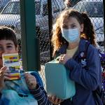 Sequim Gazette photo by Matthew Nash/ Helen Haller Elementary fourth graders Isaac Malkasian and Aubrey Jacob await their first day of school to start by talking about their Lego creations and new lunch boxes.