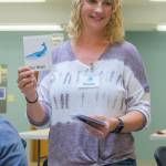Sequim Gazette photo by Emily Matthiessen / Tims Place Executive Director Rhonda Heyn holds up a bingo card during a game.